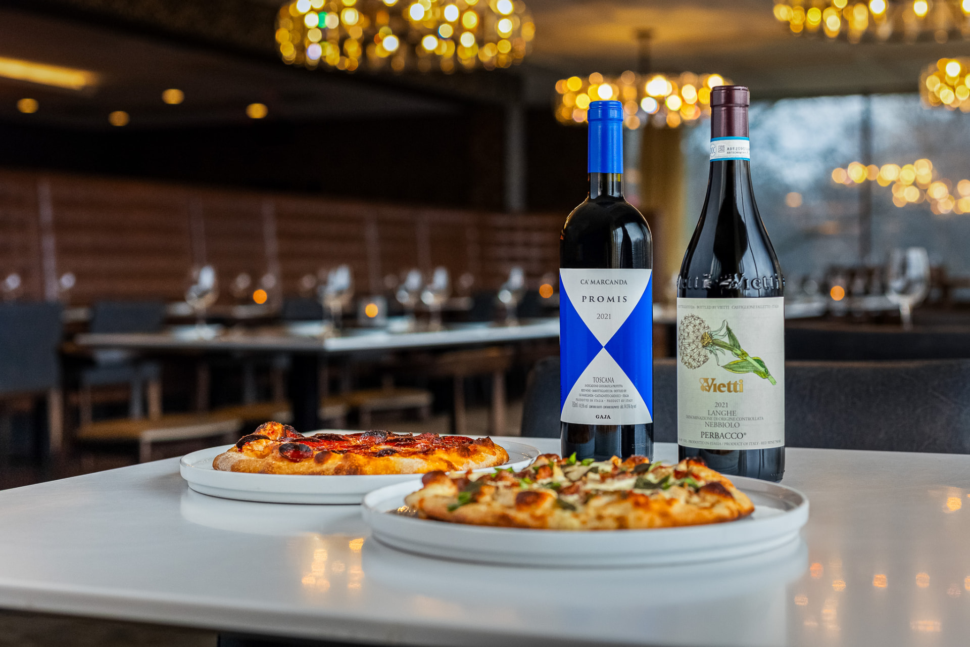 Wood-fired flatbreads and red wine on a table in the Dorf Haus dining room